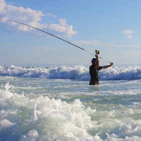 angler surf fishing in california