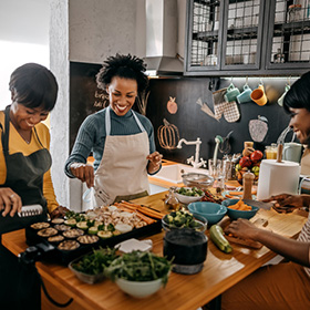 Three friends cooking Thanksgiving dinner