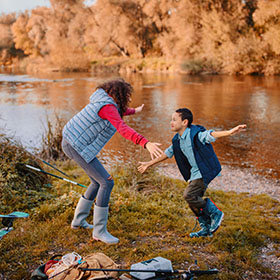 sibilings having fun outdoors fishing in the fall 