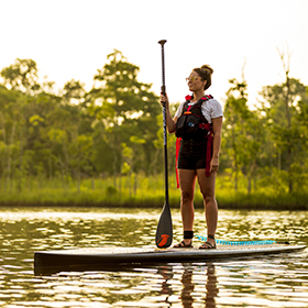 Woman standing on paddle board
