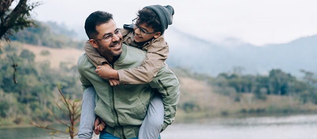 Father happily walking with his son outdoors