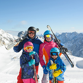 Family skiing near mountains