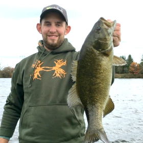 women angler holding a smallmouth bass in Minnesota