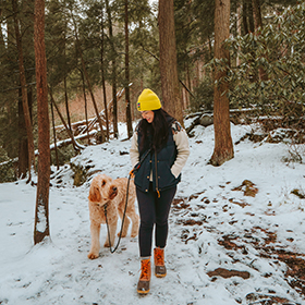 Woman in forest walking with dog