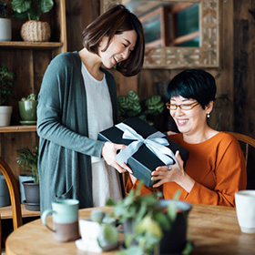 Woman receiving gift from daughter