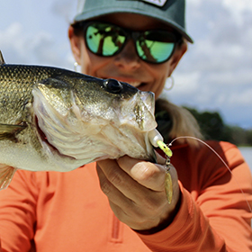 Woman holding largemouth bass