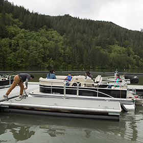 Man tying a boat to a dock