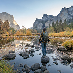 woman in a national park hiking near water