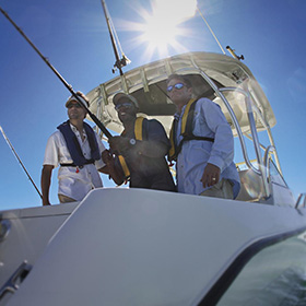 Three men fishing from boat