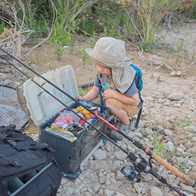 Child looking at tackle box