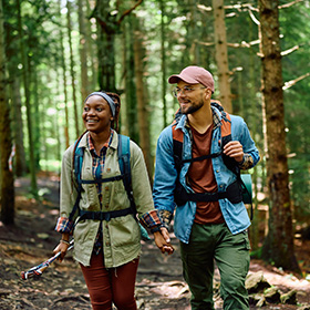 Couple walking through the woods