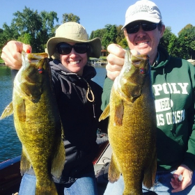 two anglers holding their catch during minnesota bass fishing season