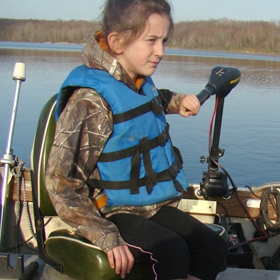 kid on a boat with a life jacket
