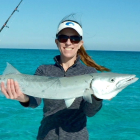 fisherwoman fishing for barracuda showing off her catch