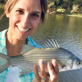 angler holding her catch while Lake Lewisville fishing