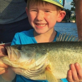 kid holding his catch at one of the best places to fish in Orlando