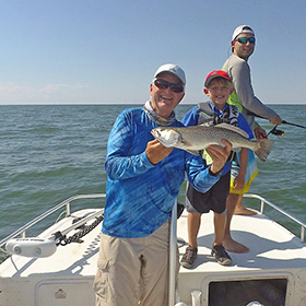 Two man and a child on boat fishing