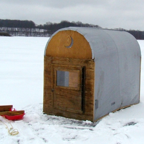 portable ice fishing shelter in the middle of a frozen lake
