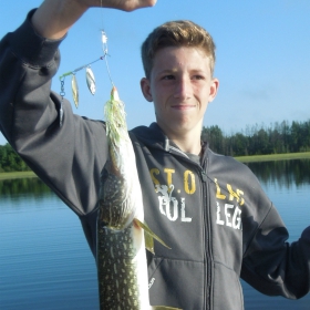 young angler showing his northern pike 