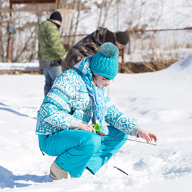 Young girl ice fishing