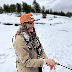 Woman fishing in snow