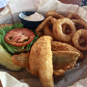 Perch sandwich with vegetables and onion rings