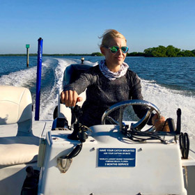 Female captain navigating boat