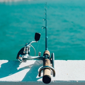 fishing rod on a pier on one of san diego fishing trips