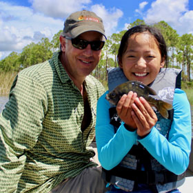 Man and girl holding a fish