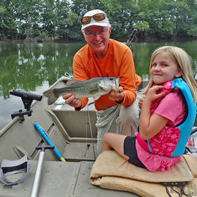 Grandfather and granddaughter fishing
