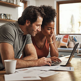 a couple looking at the computer