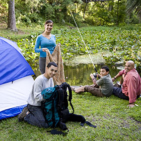 hispanic family camping and fishing