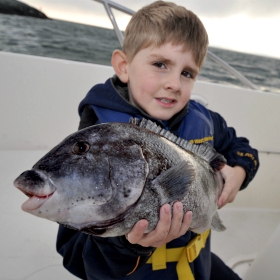 child holding a tagout fishing tips