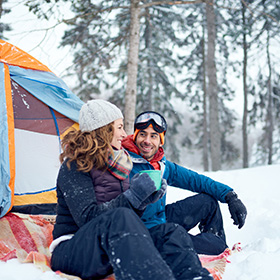 A couple camping in winter