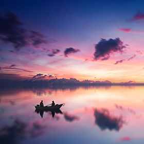 People on boat at sunset