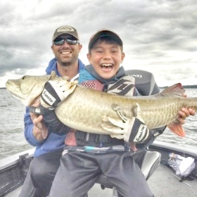 Father and son fishing for muskie in Minnesota