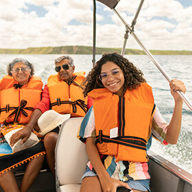 Family on boat wearing PFDs