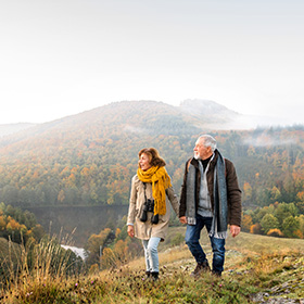 A couple walking during fall time