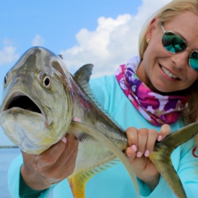 female angler shows of jack fish she caught in Florida