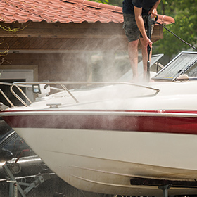 man cleaning a boat