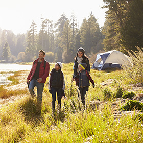 Family walking in park while camping