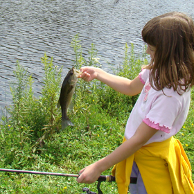 little kid fishing in a pond